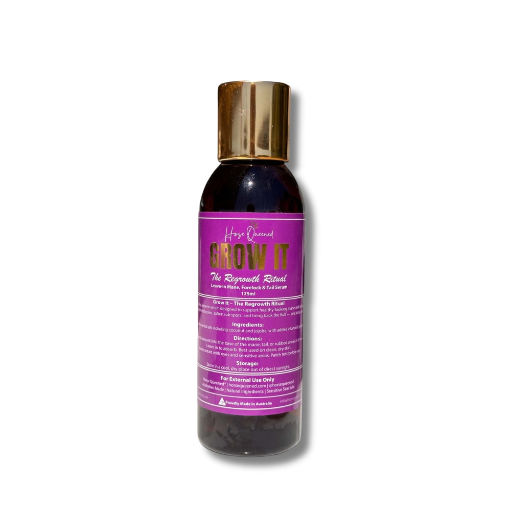 A bottle of Hair Queen Grow It Regrowth Balm, featuring a dark purple body with a metallic gold cap and a matching purple label with gold lettering.